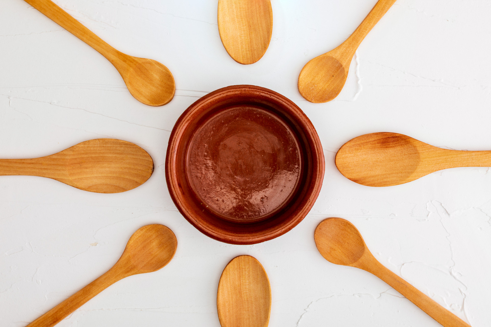 Sauce reduced in copper pan with wooden spoon