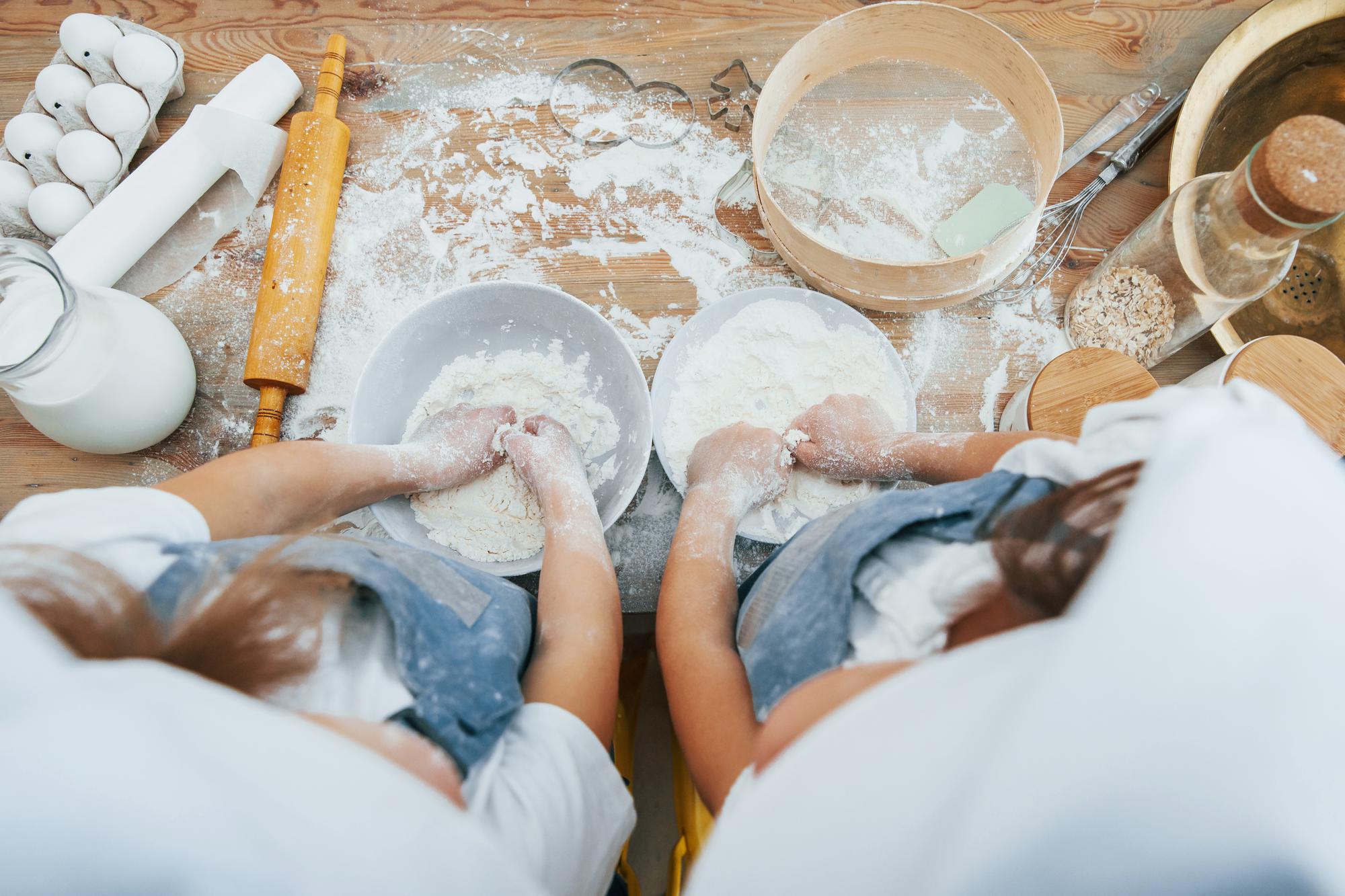 Bakers shaping loaves in workshop