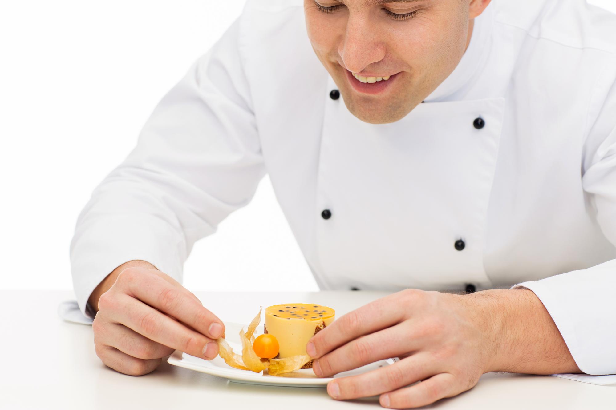 Instructor demonstrating plating in a small kitchen studio